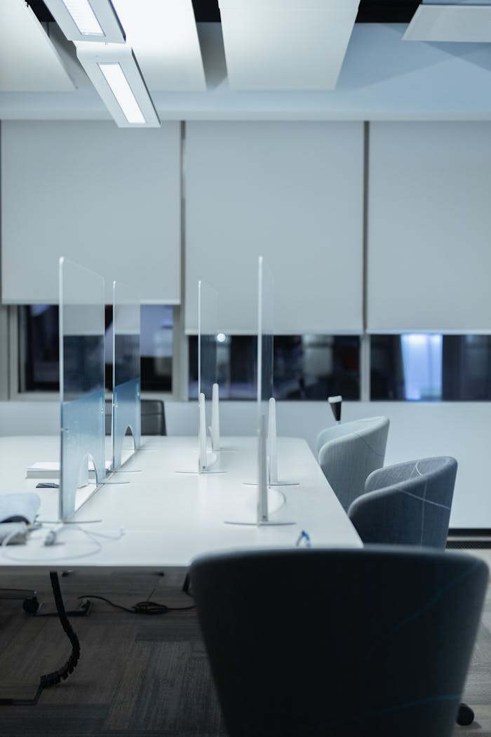 Nosotros Contemporary office setting with stylish chairs and desk dividers, perfect for productivity.